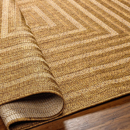Dyami Flatweave Faux Jute Outdoor Rug in natural brown tones, 3 rolled layers on display on Tampa Home & Garden Store