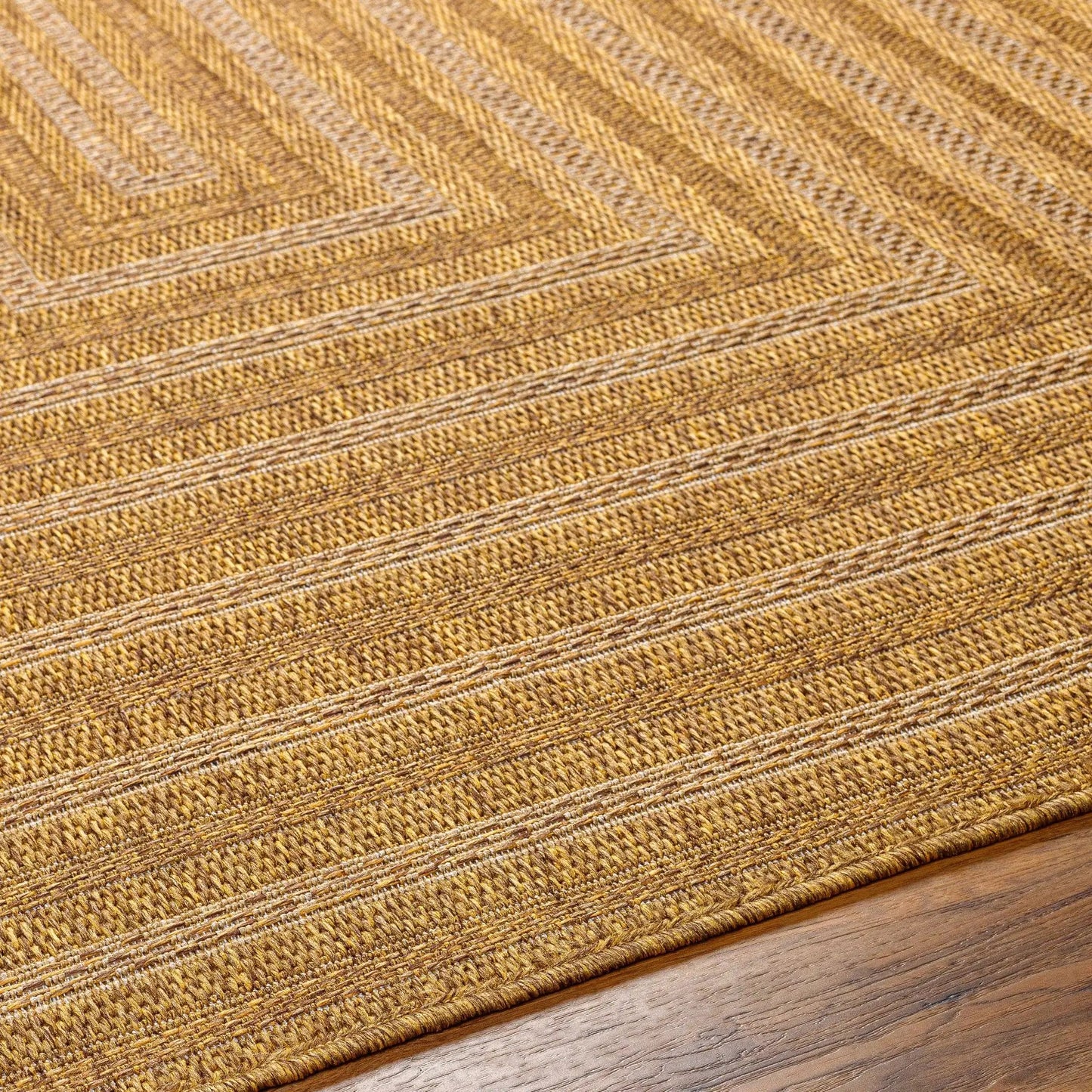 Dyami Flatweave Faux Jute Outdoor Rug in natural tan hues with textured weave on Tampa Home & Garden Store