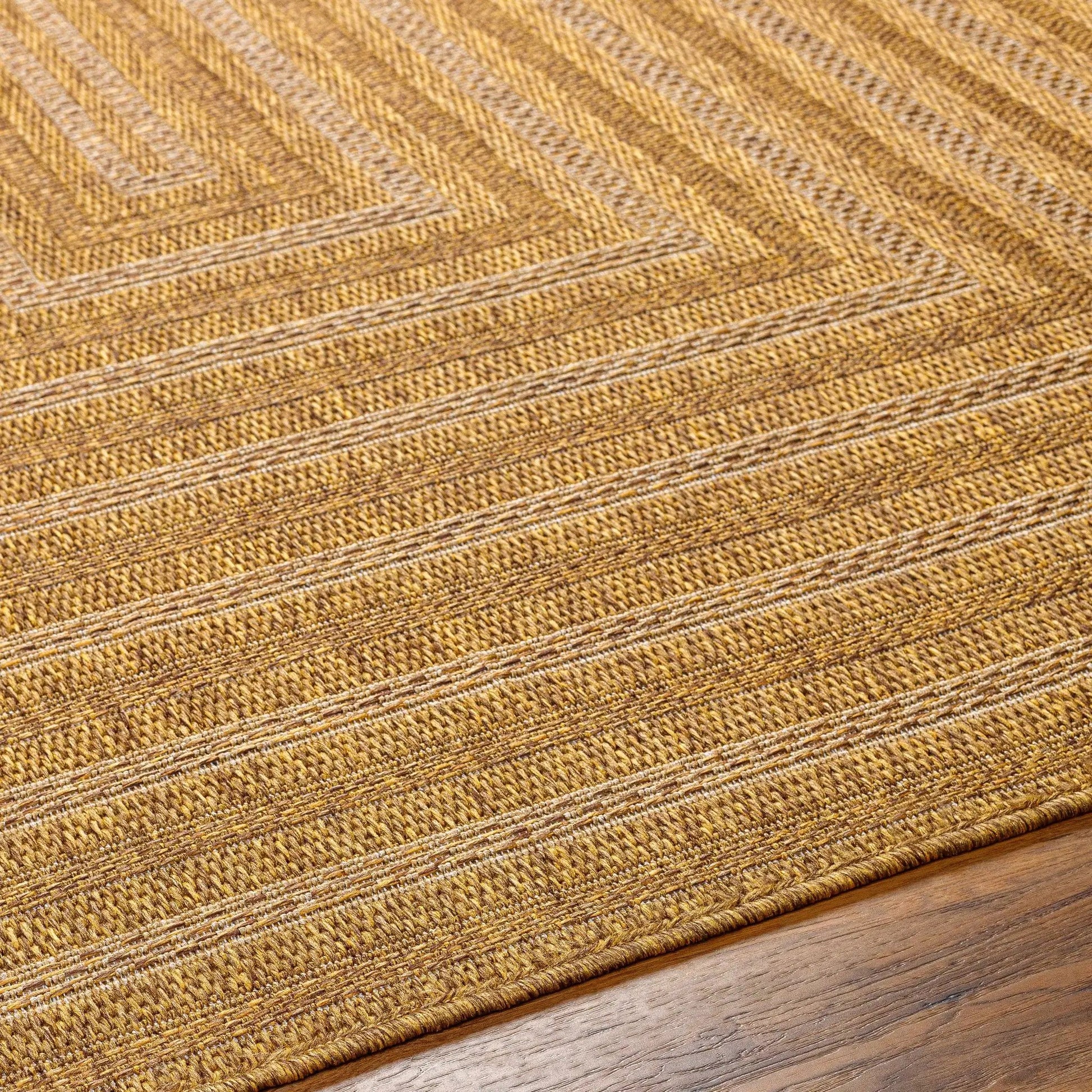 Dyami Flatweave Faux Jute Outdoor Rug in natural tan hues with textured weave on Tampa Home & Garden Store