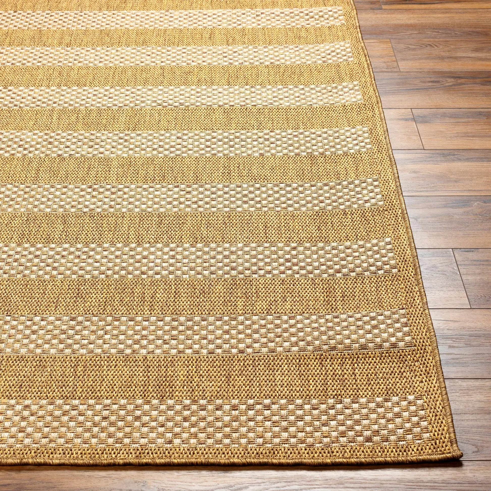 Hiero Flatweave Faux Jute Outdoor Rug tan beige striped textured weave on wood floor on Tampa Home & Garden Store