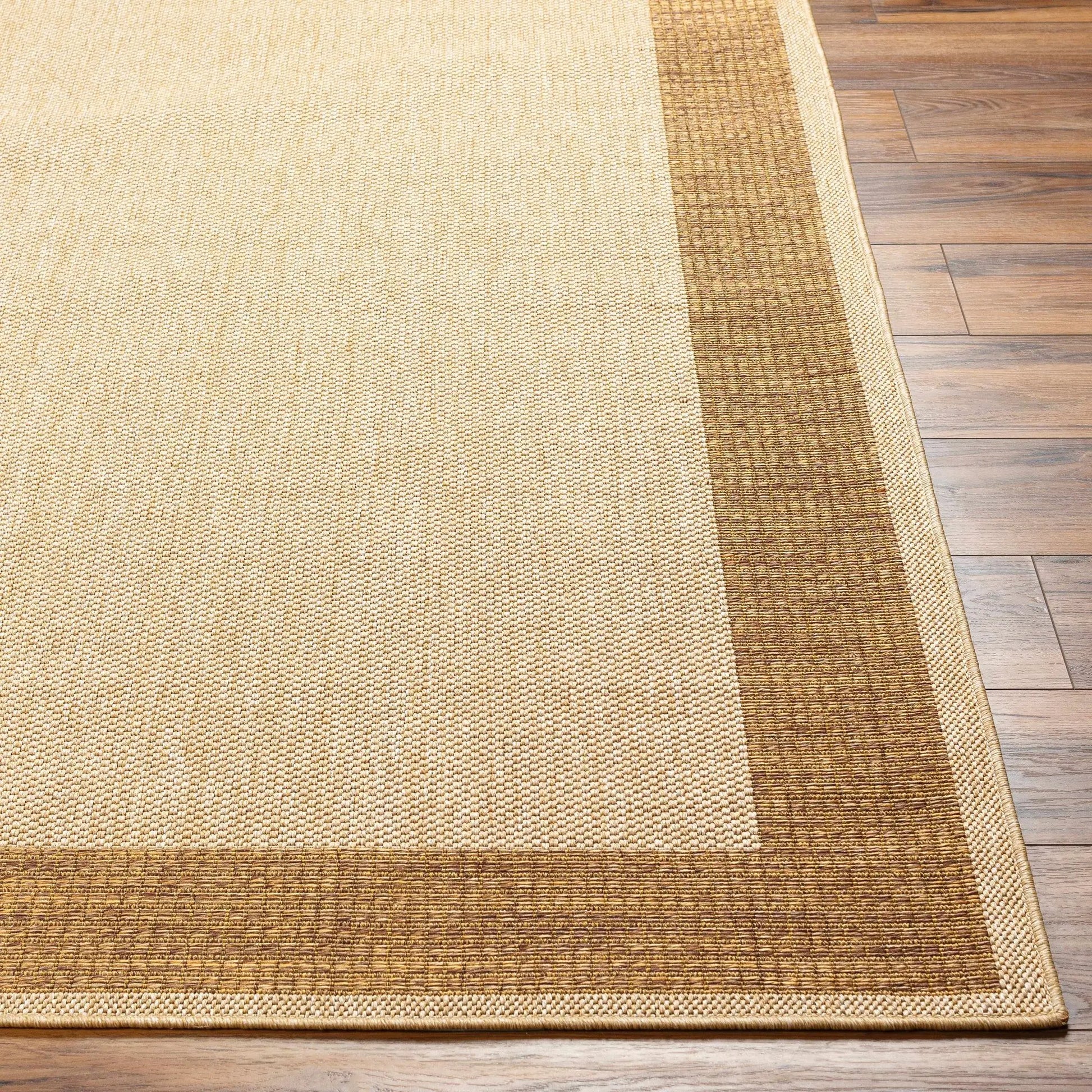 Inigo flatweave faux jute outdoor rug beige with brown border Boutique Rugs on Tampa Home & Garden Store