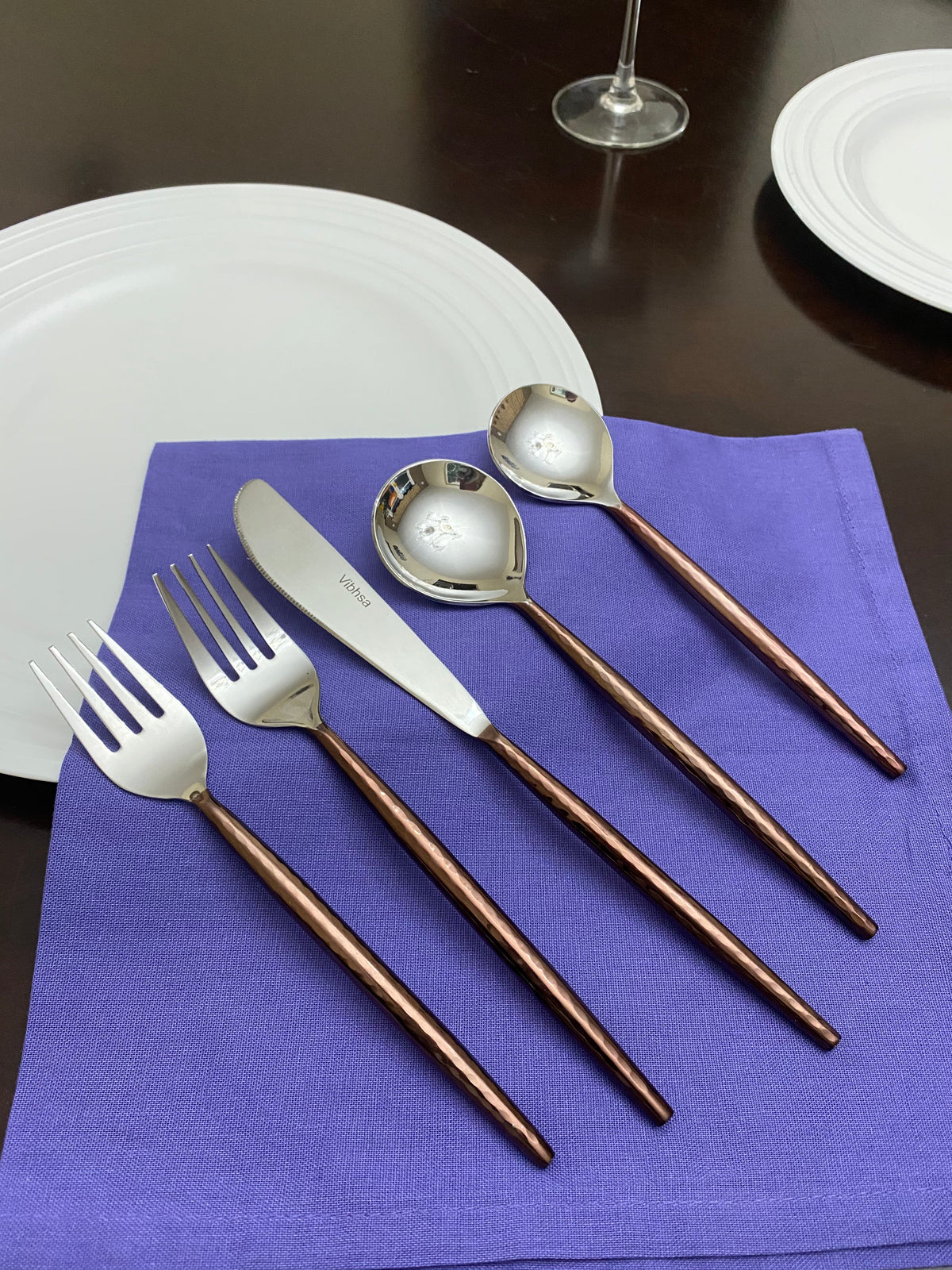 Hammered stainless steel flatware with copper-brown handles by Vibhsa, 20-piece set on napkin on Tampa Home & Garden Store
