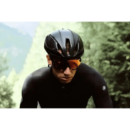 Sport riding sunglasses by Stevvex for men, orange lenses, sleek black frame worn by a cyclist on Tampa Home & Garden Store