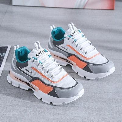 Stevvex athletic running shoes pair, white mesh with teal lining and orange gray accents on Tampa Home & Garden Store