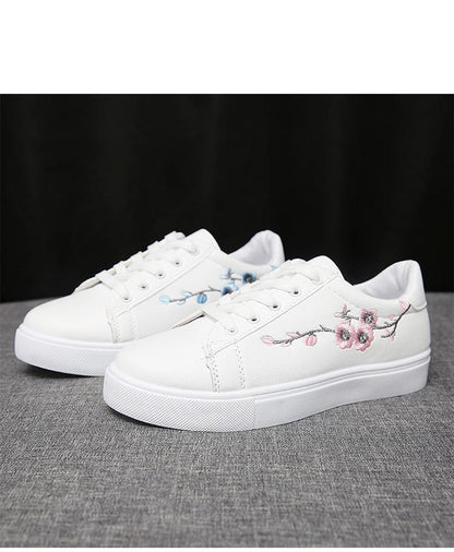 Pair of white PU leather platform sneakers with blue and pink floral embroidery on Tampa Home & Garden Store