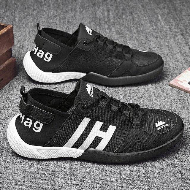 Stevvex black mesh sneakers (pair) with white sole, breathable casual IH graphic on Tampa Home & Garden Store
