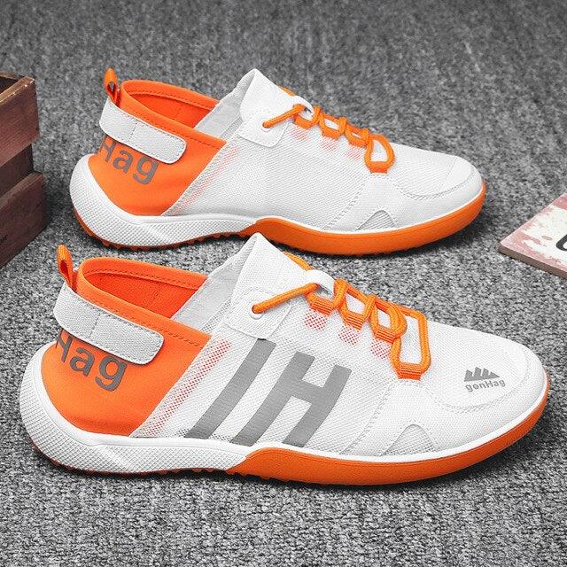 Stevvex ST85SH5500REH sneakers pair, white mesh upper with orange accents and orange sole on Tampa Home & Garden Store
