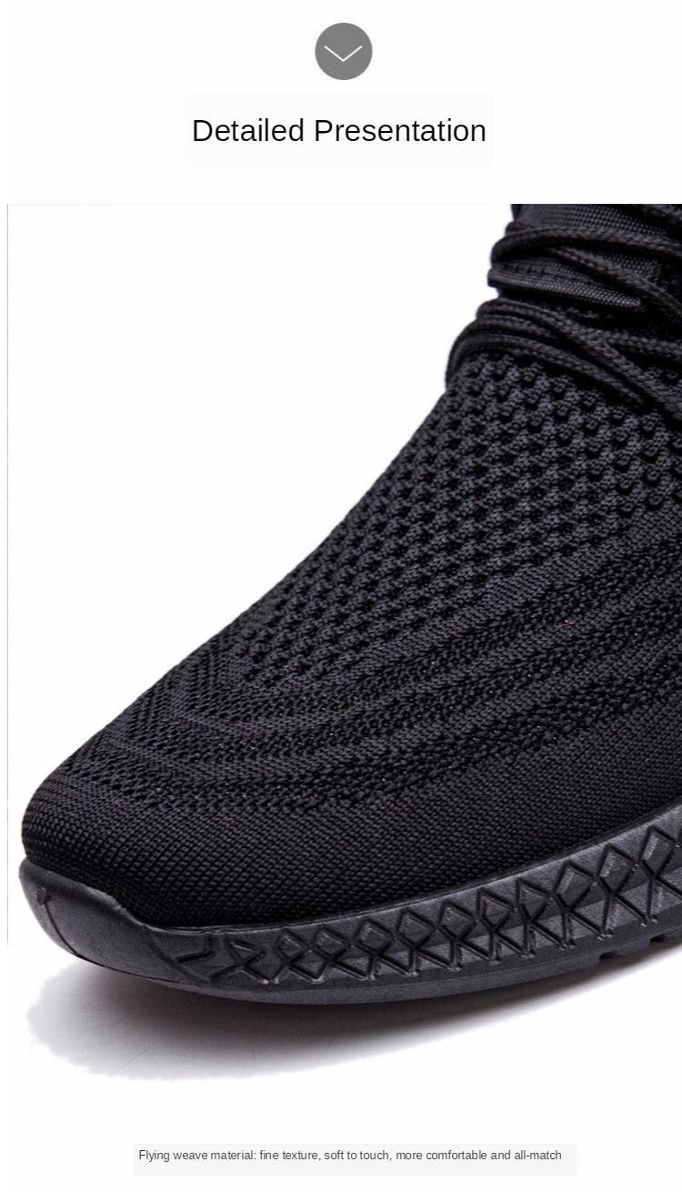 Black knit mesh men's sneakers with sock-like collar and textured sole, close-up toe view on Tampa Home & Garden Store