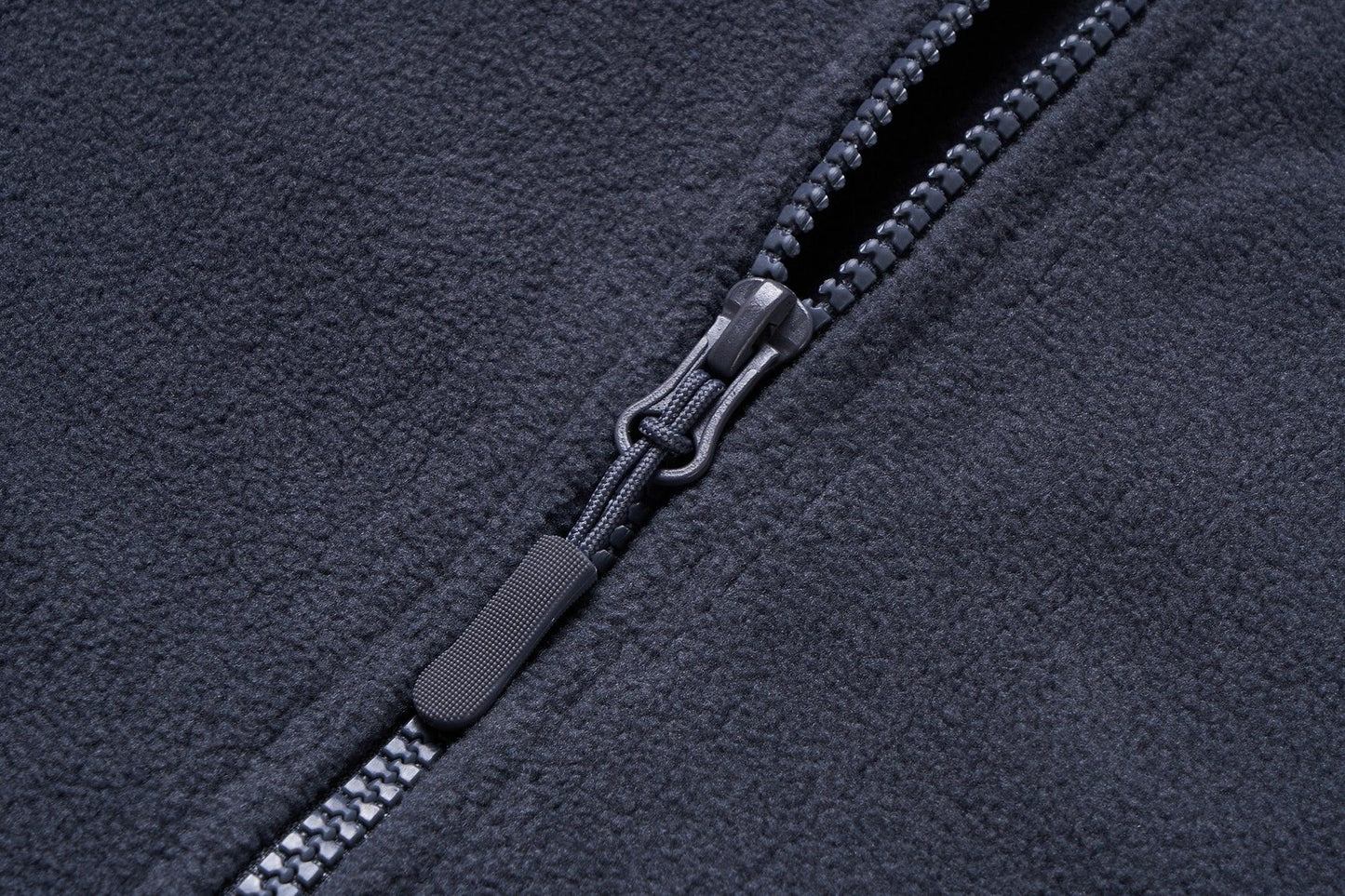 Fleece jacket close-up in dark charcoal with zipper and cord pull windproof fabric on Tampa Home & Garden Store