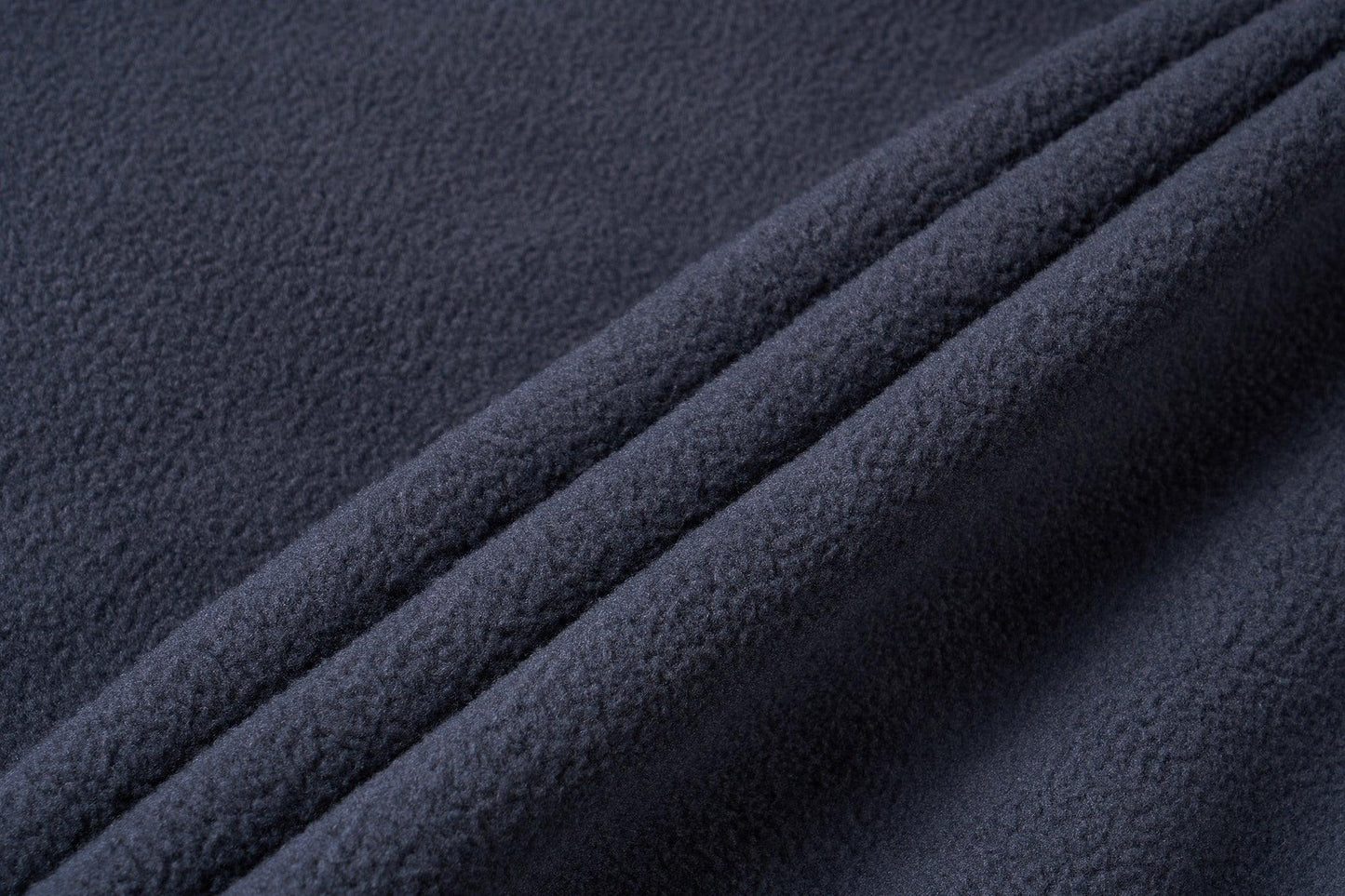 Navy fleece fabric close-up with folded texture for Stevvex windbreaker jacket on Tampa Home & Garden Store