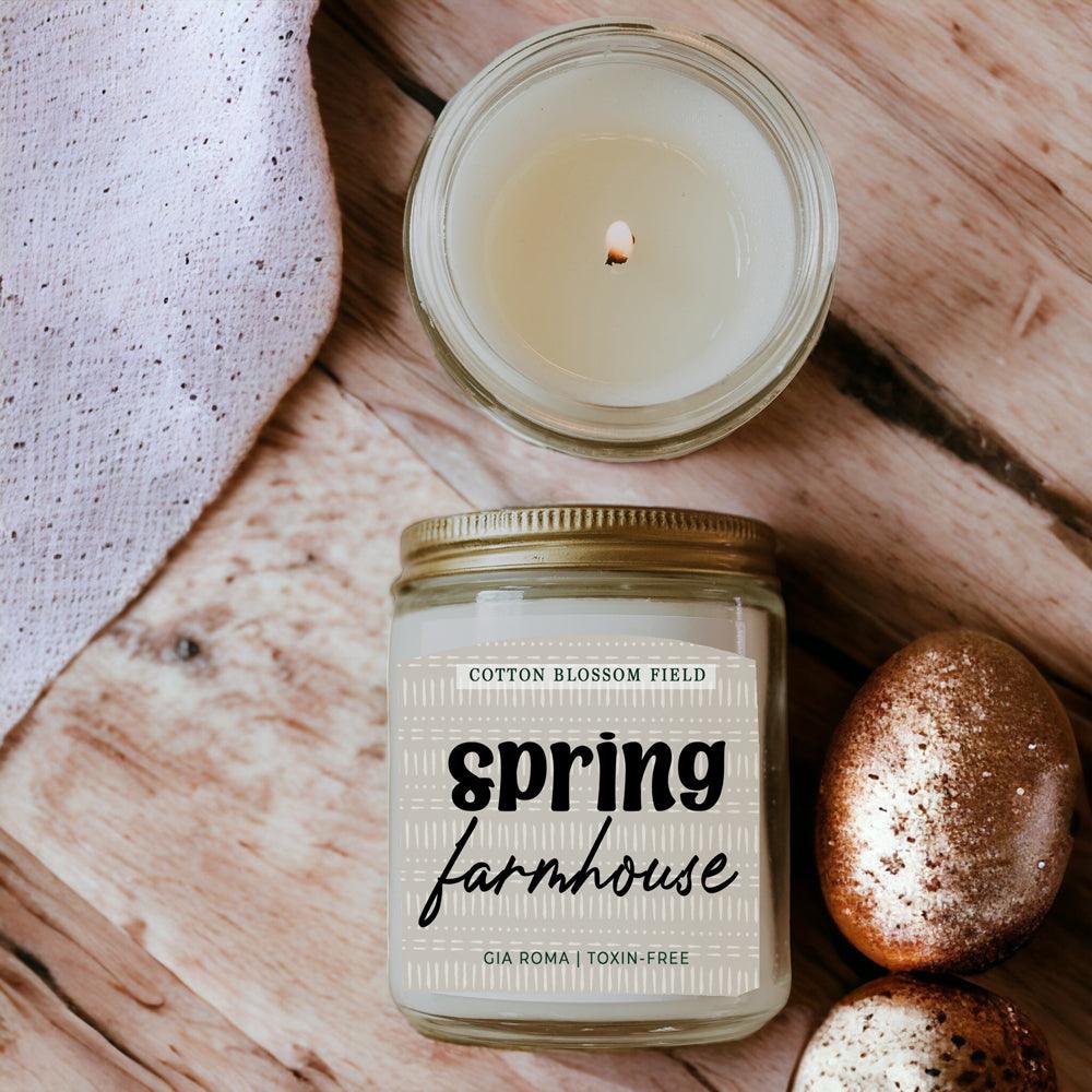 Cotton Blossom Candle by Gia Roma in a clear glass jar with gold lid, spring farmhouse label on wood with two eggs on Tampa Home & Garden Store
