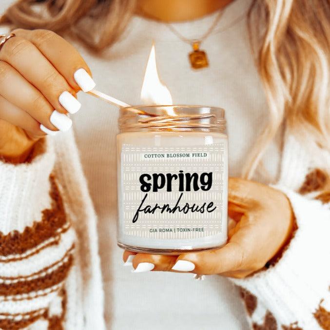 Cotton Blossom Candle by Gia Roma in a clear jar with white wax, lit for a cozy spring moment on Tampa Home & Garden Store