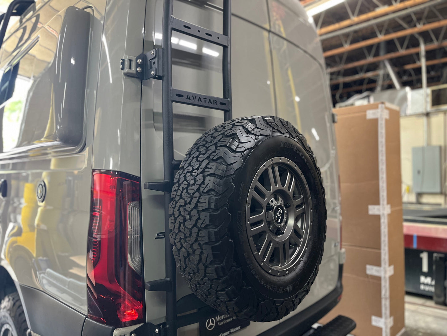 Avatar Van Rear Ladder Tire Carrier mount on back of gray Mercedes van with spare tire on Tampa Home & Garden Store