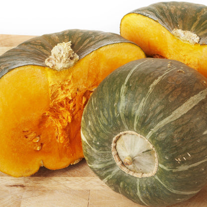 Burgess Buttercup squash with green rind and bright orange flesh, sliced to show interior on Tampa Home & Garden Store