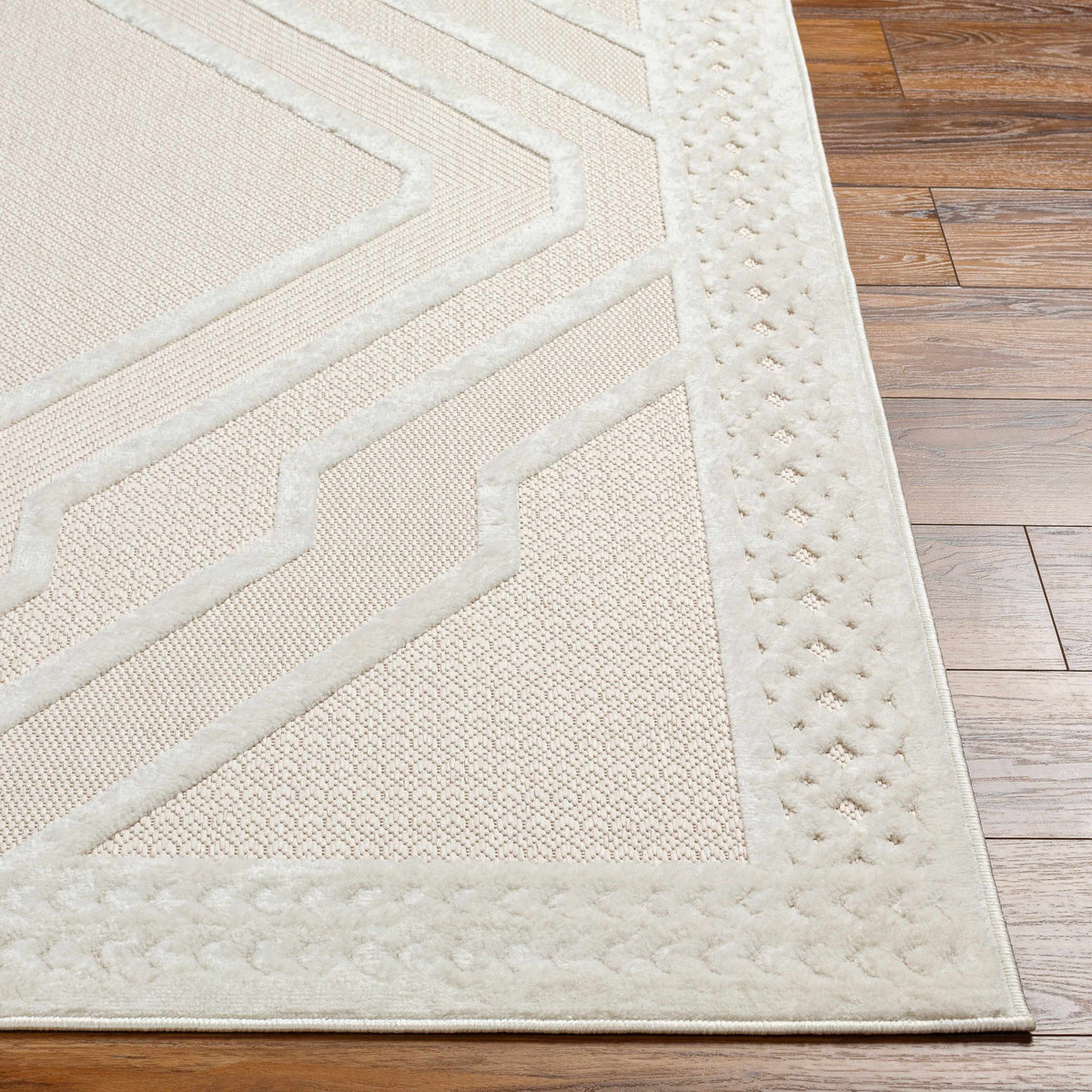 Anja Cream Outdoor Rug by Boutique Rugs with cream weave and geometric border on wood floor on Tampa Home & Garden Store