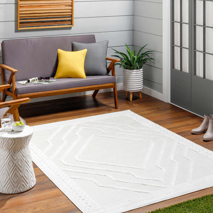 Anja Cream Outdoor Rug with textured geometric pattern on a porch seating area on Tampa Home & Garden Store