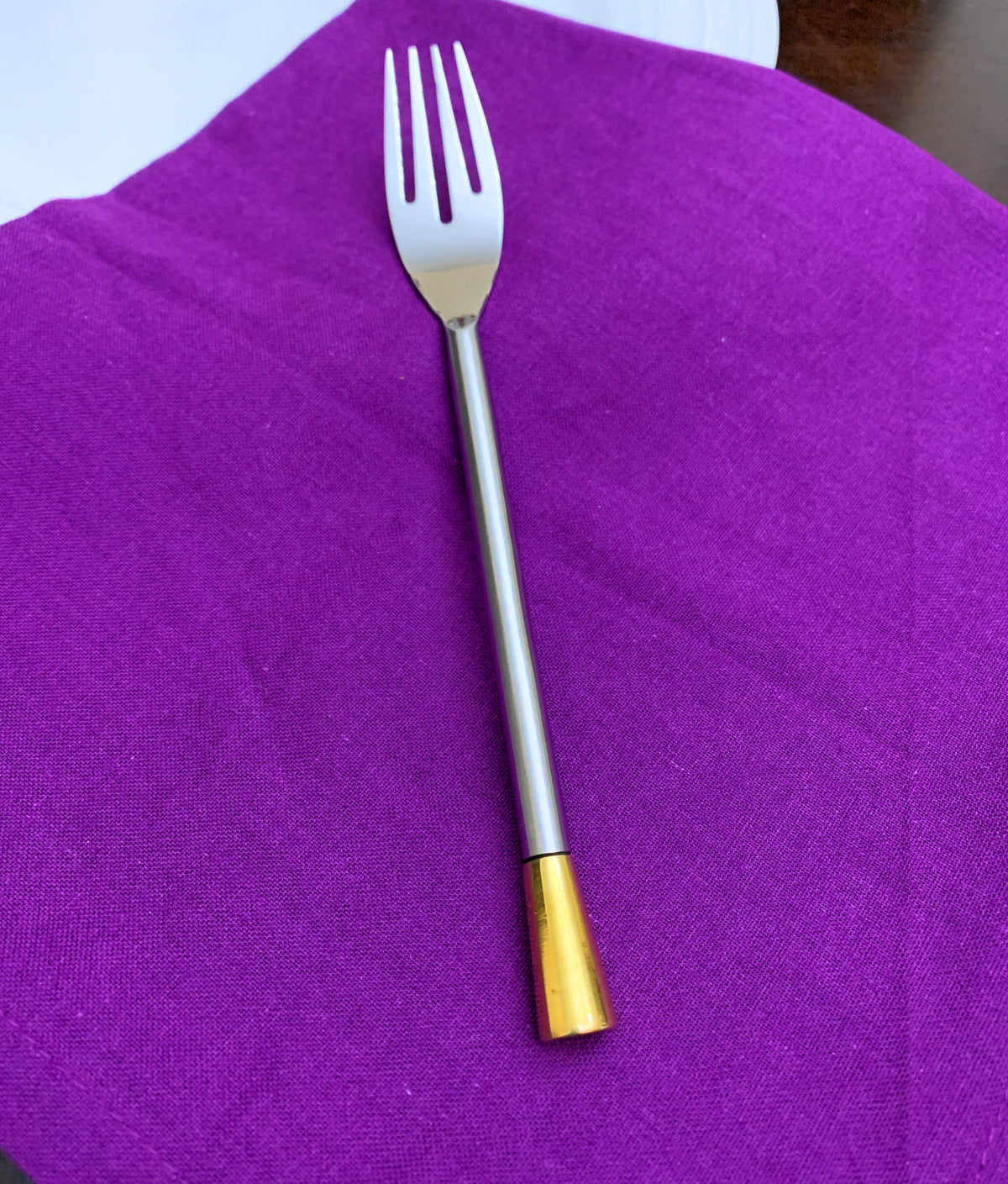 Vibhsa flatware fork stainless steel with gold-tone handle on purple napkin on Tampa Home & Garden Store