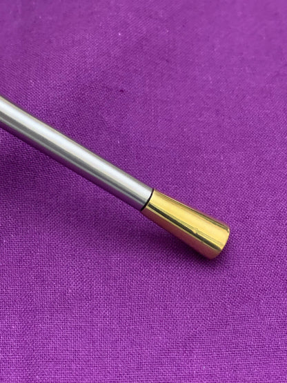 Vibhsa flatware handle with silver body and gold-tone end cap on purple fabric background on Tampa Home & Garden Store