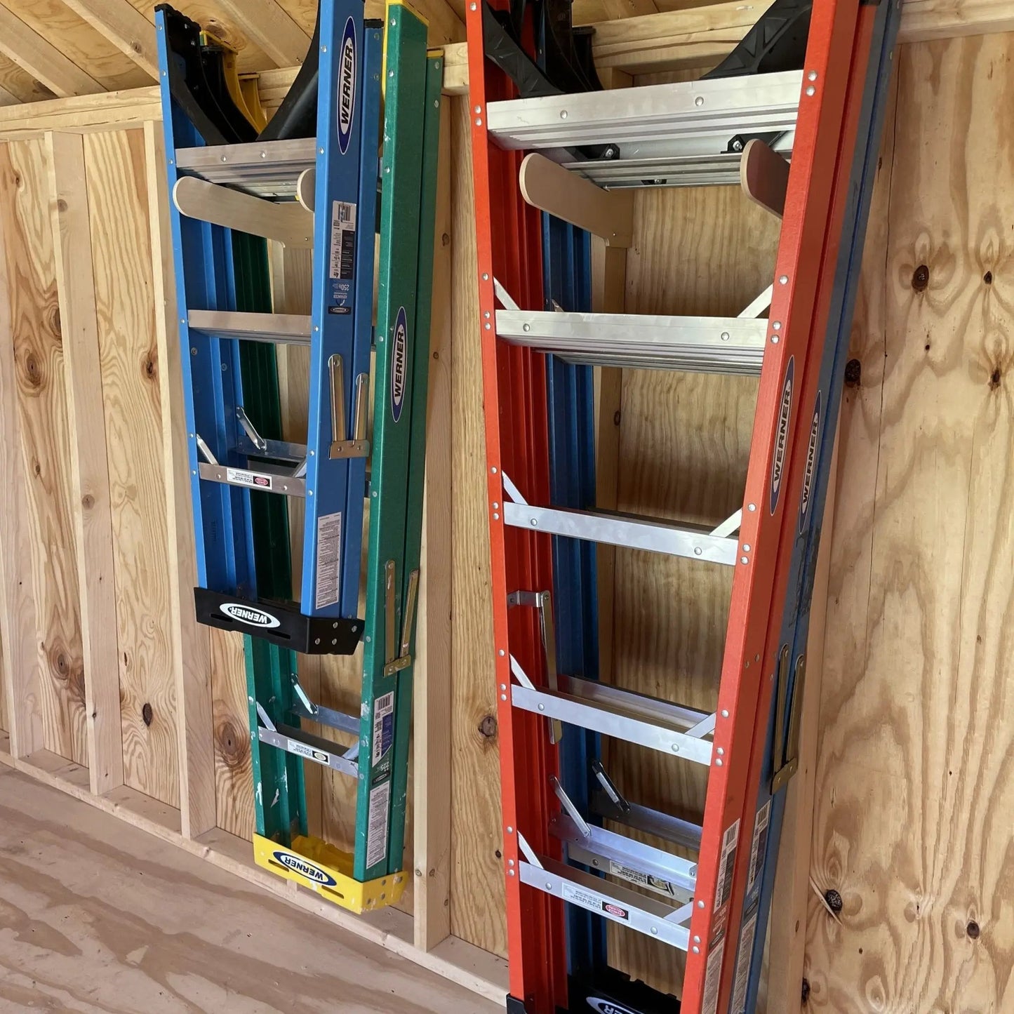 Deluxe tool rack organizer in blue and red metal frames with aluminum rungs on shed wall on Tampa Home & Garden Store