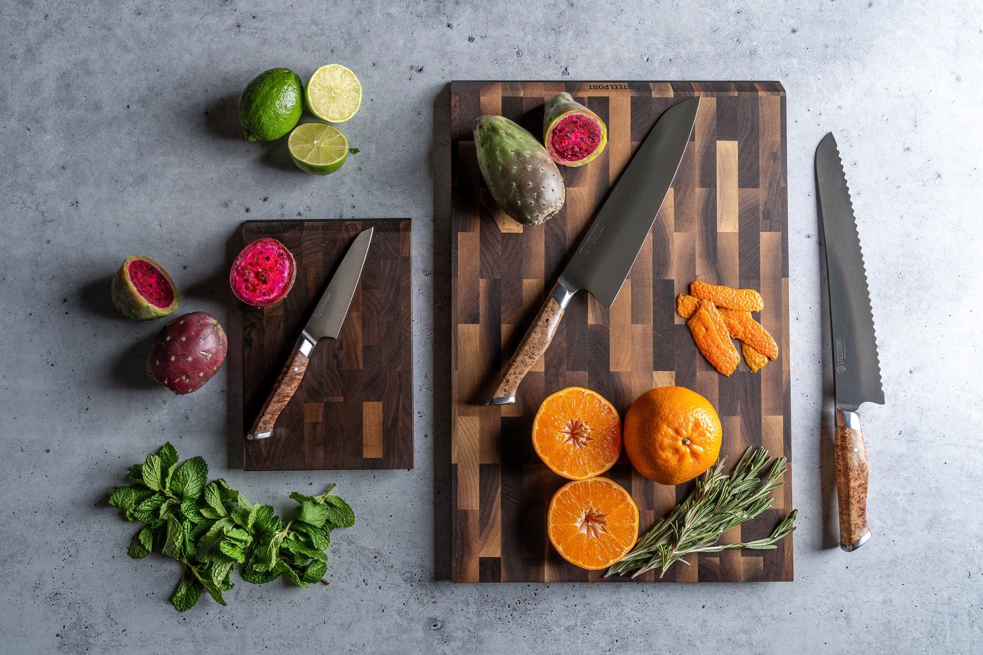 Signature Knife & Board Set by STEELPORT on two dark wooden boards with kitchen knives on Tampa Home & Garden Store