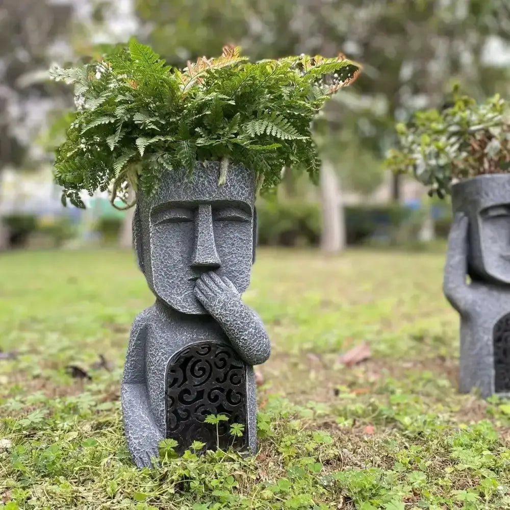 Stone gray Easter Island moai planter statue with lush fern top on Tampa Home & Garden Store