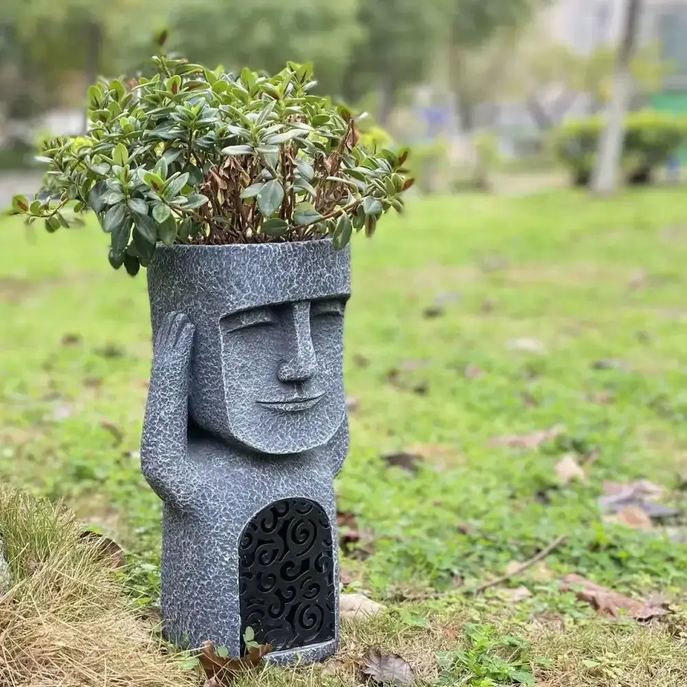 Stone gray moai planter statue with textured finish and green plant top Decorbites on Tampa Home & Garden Store
