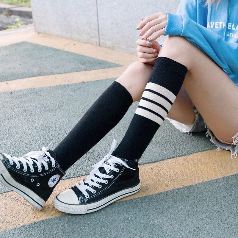 Stevvex striped long warm thigh high stockings black with white bands worn on two legs on Tampa Home & Garden Store