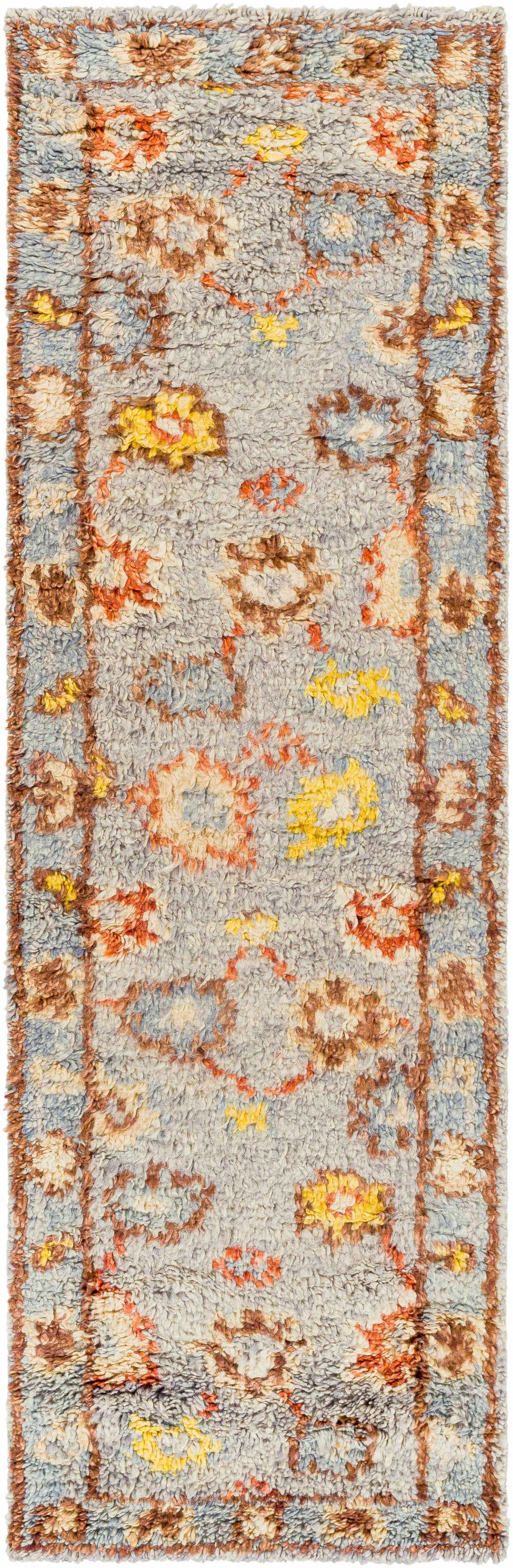 Suisun Premium Rug by Boutique Rugs, blue gray shag with orange yellow floral motifs on Tampa Home & Garden Store
