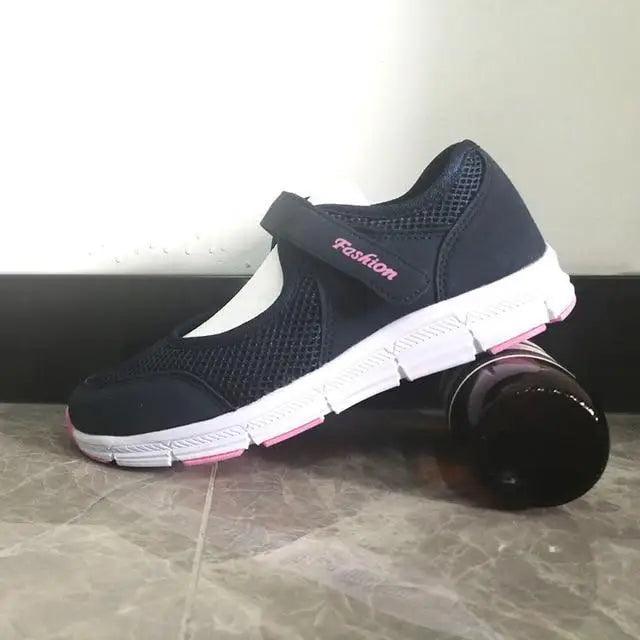 Women's navy breathable mesh sneakers with white sole, pink accents and velcro strap on Tampa Home & Garden Store
