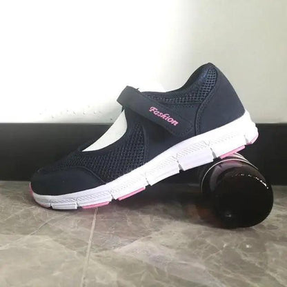 Women's navy breathable mesh sneakers with white sole, pink accents and velcro strap on Tampa Home & Garden Store