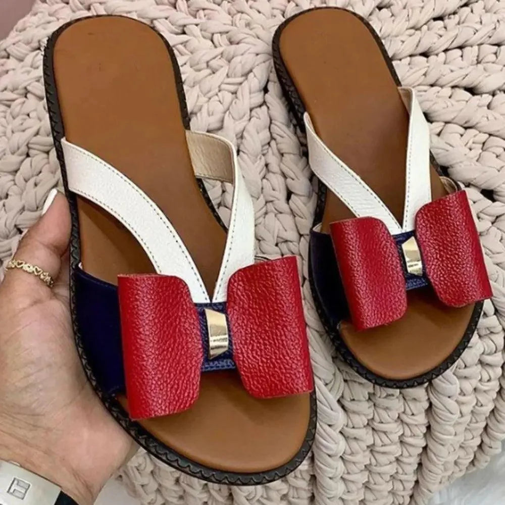 Butterfly sandals by Stevvex pair with white Y-straps red bows navy panels tan footbed black sole on Tampa Home & Garden Store
