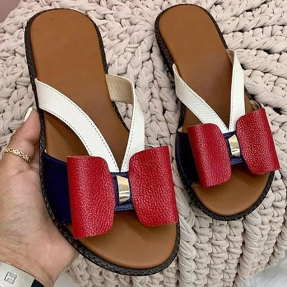 Butterfly sandals by Stevvex pair with white Y-straps red bows navy panels tan footbed black sole on Tampa Home & Garden Store