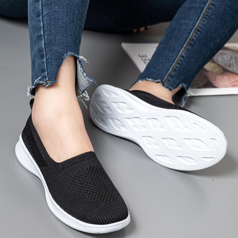 Black knit slip-on sneakers with breathable mesh upper and white sole for comfort on Tampa Home & Garden Store