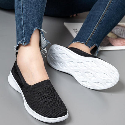 Black knit slip-on sneakers with breathable mesh upper and white sole for comfort on Tampa Home & Garden Store