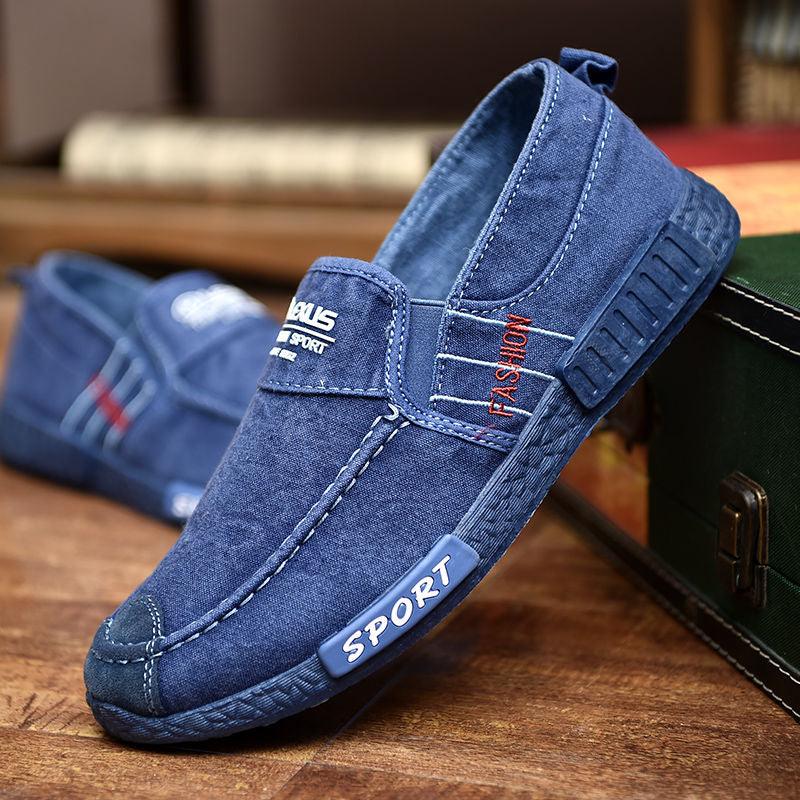 Pair of Stevvex blue denim slip-on loafers with sport label and orange FASHION embroidery, shoes on Tampa Home & Garden Store