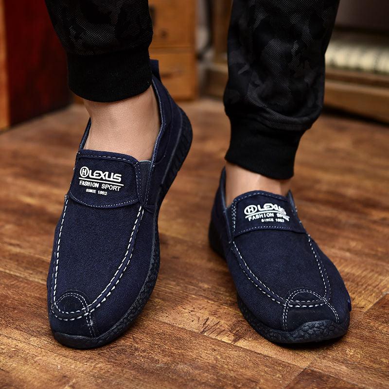 Two navy canvas slip-on loafers with white stitching and Lexus logo patches on Tampa Home & Garden Store