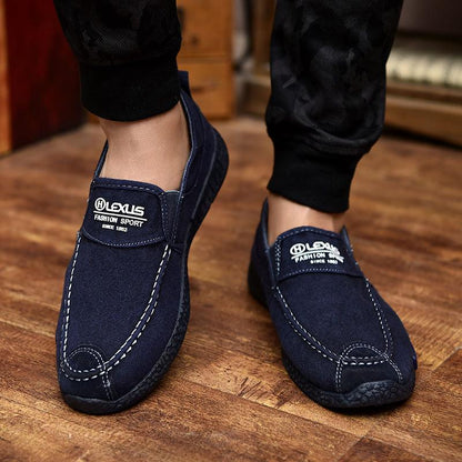 Two navy canvas slip-on loafers with white stitching and Lexus logo patches on Tampa Home & Garden Store