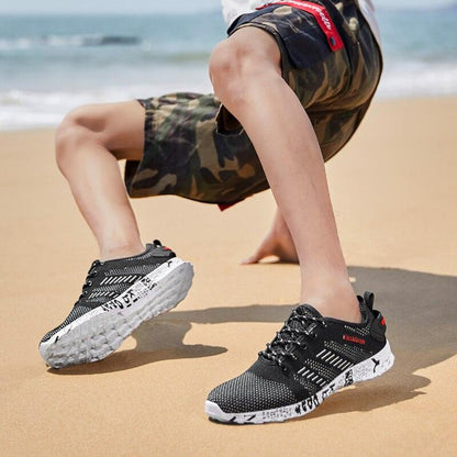 Stevvex Summer Sport men's black air-mesh sneakers with white foam sole on beach on Tampa Home & Garden Store