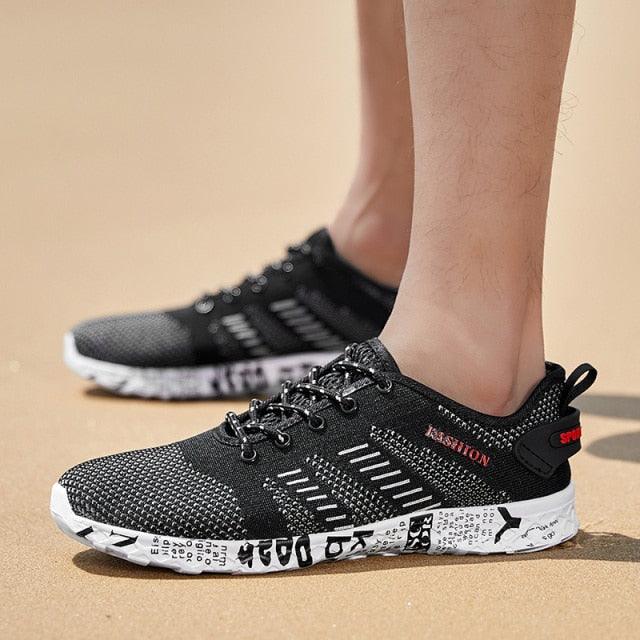 Pair of Stevvex black air-mesh sneakers with white foam sole, lace-up athletic shoes on Tampa Home & Garden Store