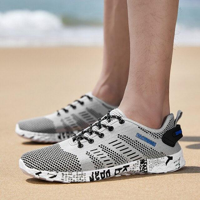 Stevvex sneakers, pair of white gray breathable mesh shoes with black laces and foam sole on Tampa Home & Garden Store