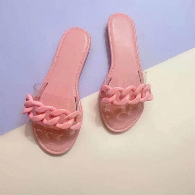 Pair of pink chain-strap slide sandals for women with open toe and flat sole on Tampa Home & Garden Store