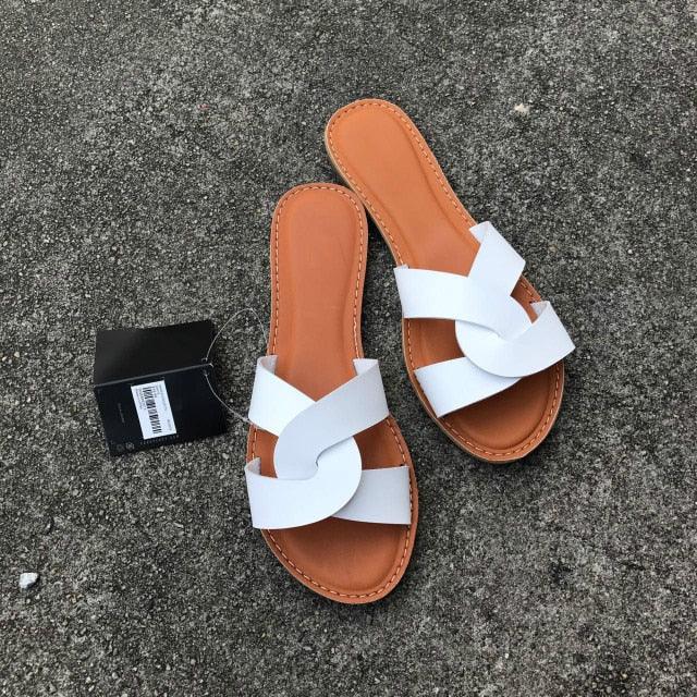 pair of Stevvex white cross-strap leather sandals with tan footbed on Tampa Home & Garden Store