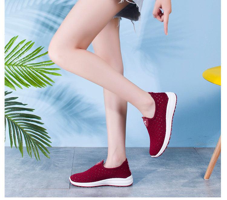 Women's burgundy breathable mesh slip-on sneakers with white sole worn by model on Tampa Home & Garden Store
