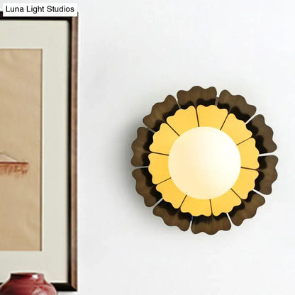 Yellow wood wall sconce in sunflower design with brown outer petals and white center on wall on Tampa Home & Garden Store