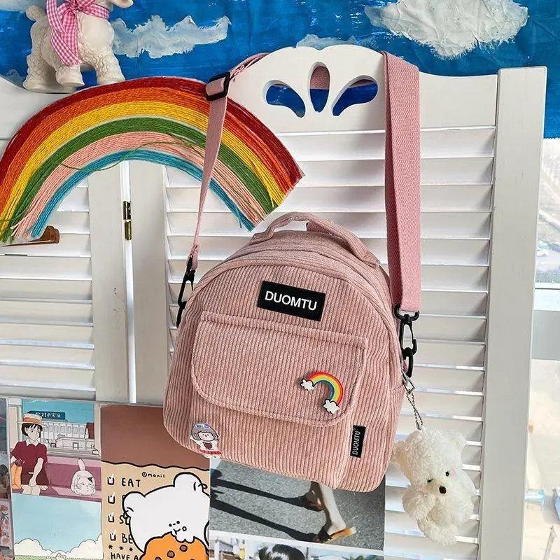 Stevvex pink corduroy mini backpack with front pocket, rainbow patch and plush keychain on Tampa Home & Garden Store