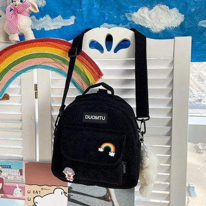 Mini black corduroy backpack by Duomtu with rainbow patch and fluffy keychain on Tampa Home & Garden Store