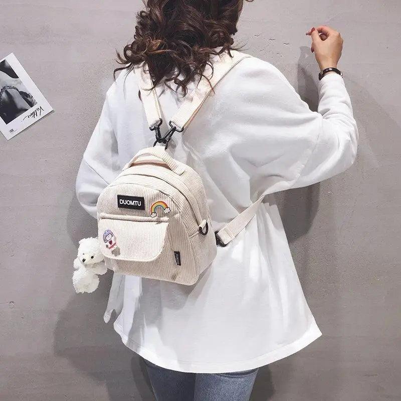 Backpack Stevvex beige corduroy small with front patch pocket and plush keychain worn by model on Tampa Home & Garden Store