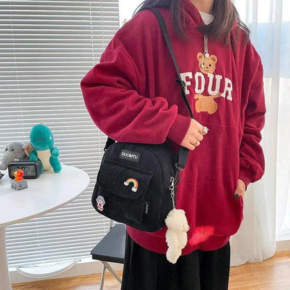 Small Stevvex backpack with pocket patch rainbow charm, crossbody worn by model in red hoodie on Tampa Home & Garden Store