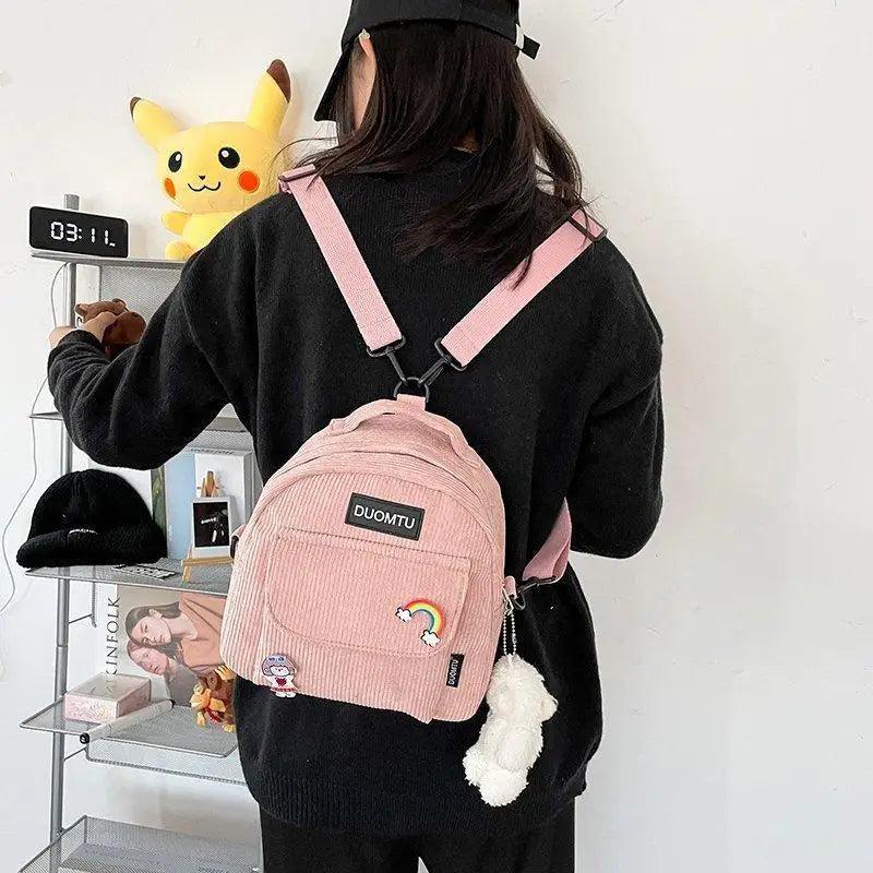 Stevvex pink corduroy mini backpack with rainbow and cloud patches and fluffy pom keychain on Tampa Home & Garden Store