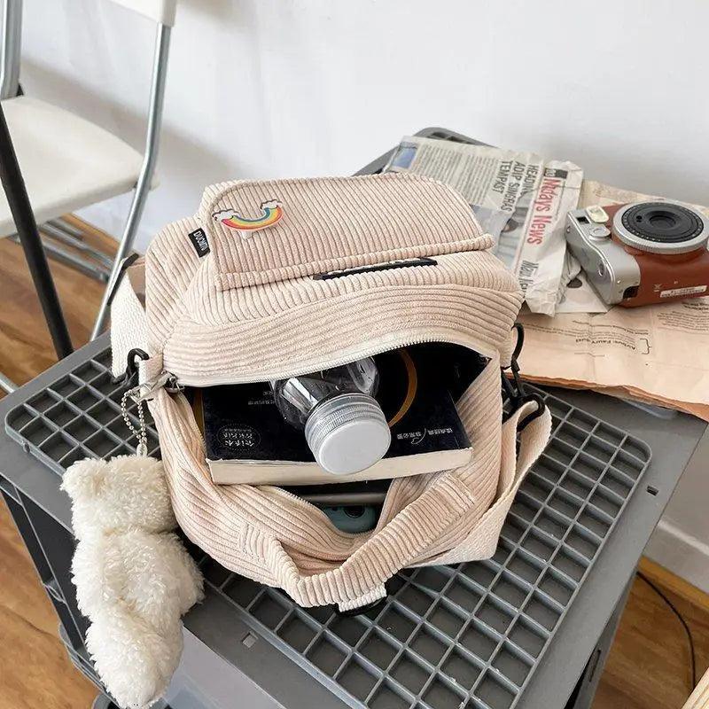 Stevvex small beige corduroy backpack with rainbow patch, front pocket, and fluffy pompom keychain on Tampa Home & Garden Store